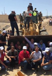 Residents and supporters of the Palestinian Bedouin village Khan al Ahmar sit in front of Israeli bulldozers. Israeli authorities have been forcibly evicting residents in order to demolish the village to make room for more illegal Israeli settlements