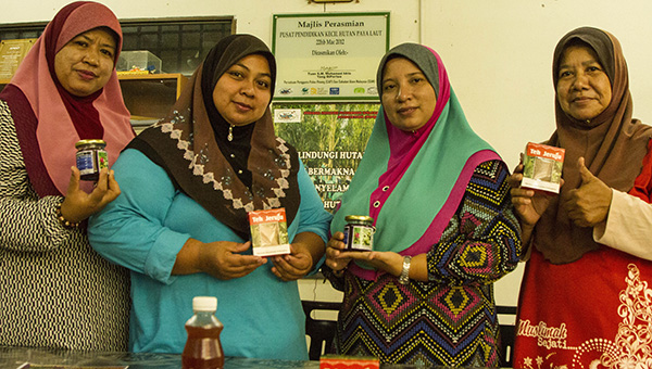 two women exhibiting homemade jam and health remedies